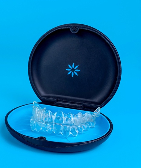Invisalign trays in carrying case with blue background